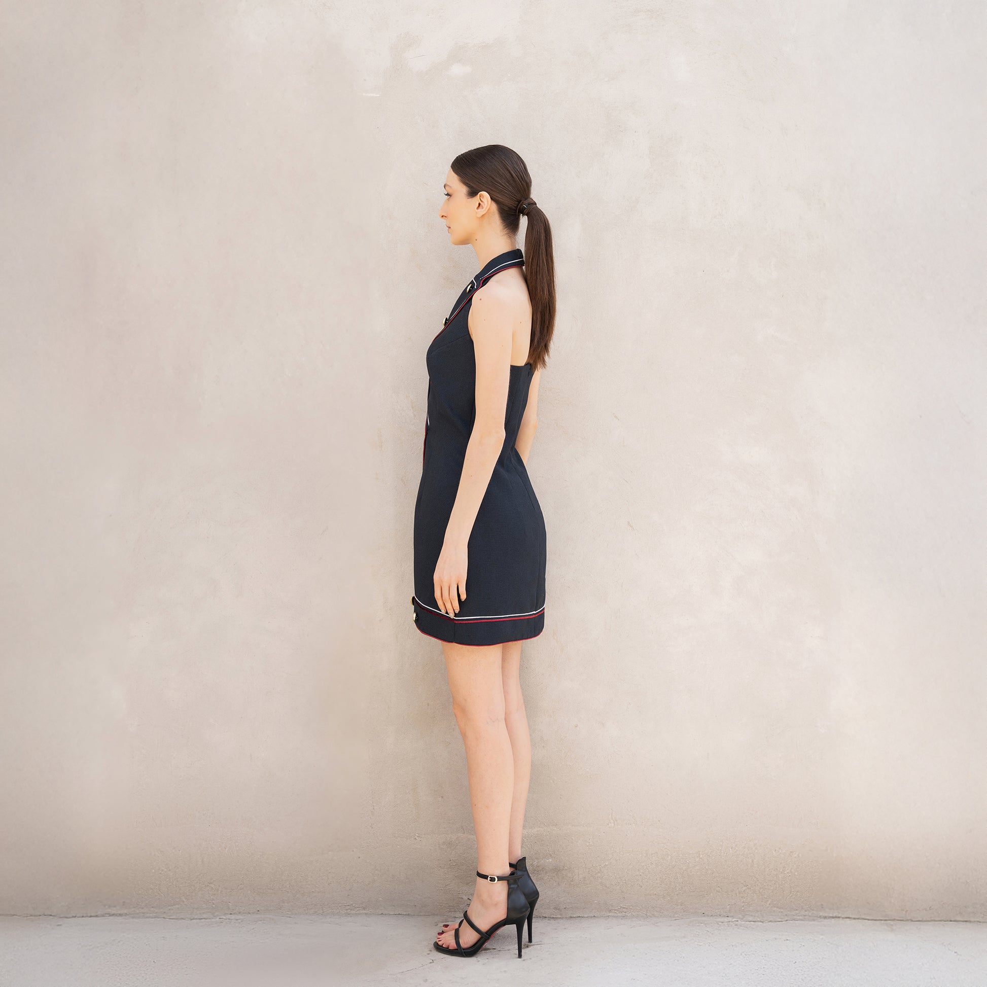 Side angle of the Pulse dress, emphasizing the streamlined silhouette and detailing on the edges.